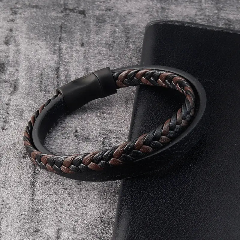Men’s braided leather bracelet with black and brown strands and magnetic clasp displayed on front side.