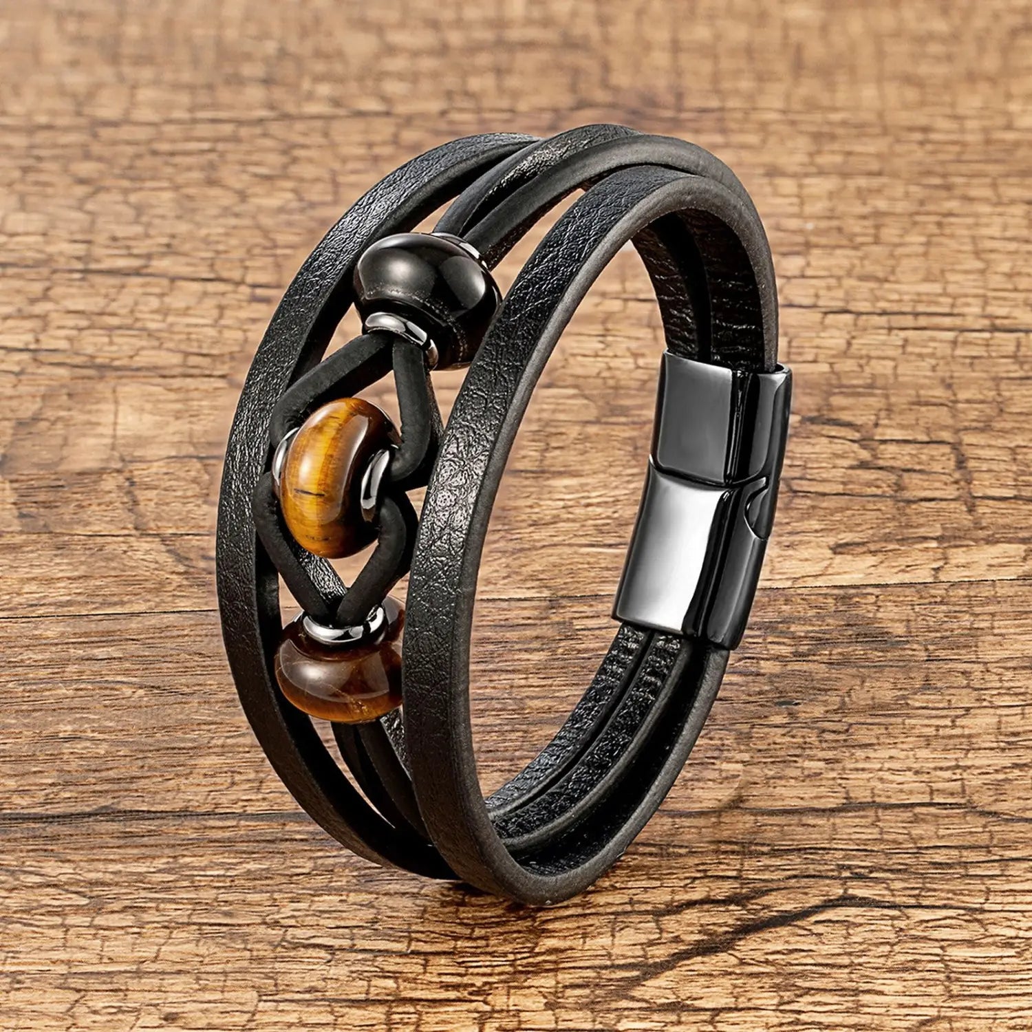 Bracelet en cuir noir à cordons multiples, présentant des perles en pierre naturelle d’œil-de-tigre et d’onyx, avec une fermeture magnétique.
