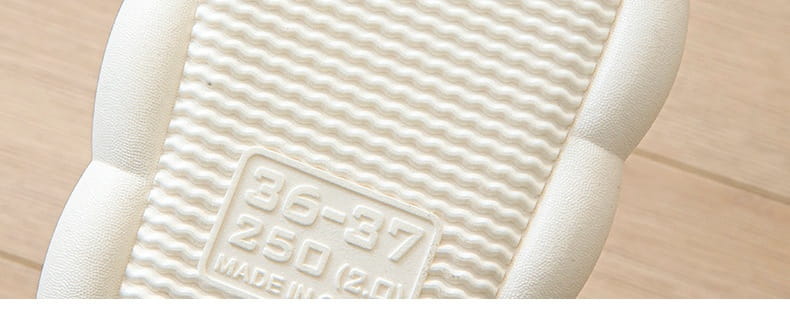 white rubber sole with wavy texture and embossed size label on the back side of cartoon animal embroidered open toe linen slippers