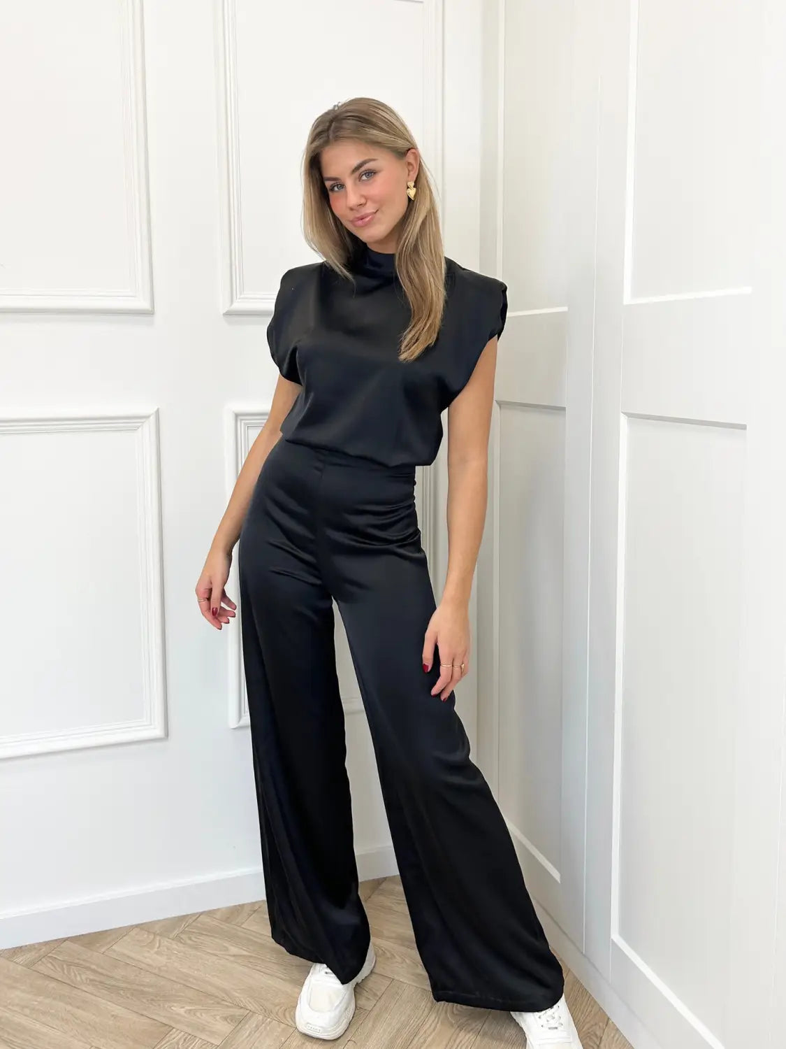 Black satin backless evening dress jumpsuit with ruched waist, puff sleeves, and straight pants in a two-piece set.