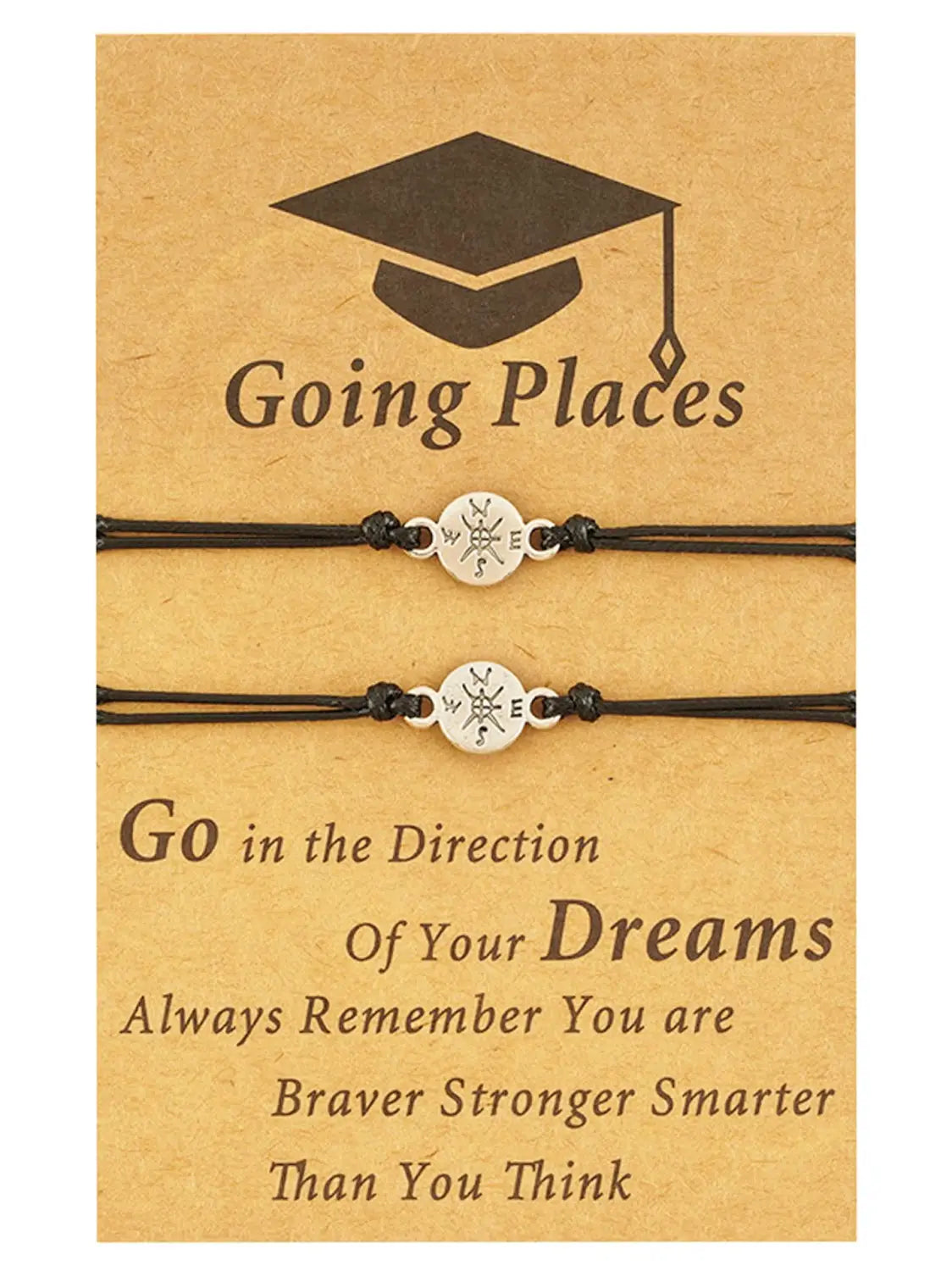 Black cord graduation adventure bracelet with a silver compass charm displayed on brown cardstock backing