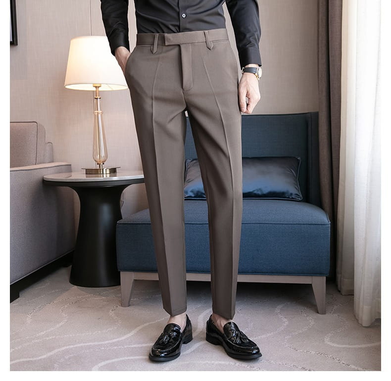 A pair of men’s slim fit British style tailored straight leg brown trousers with a sleek modern cut and subtle front pleats.