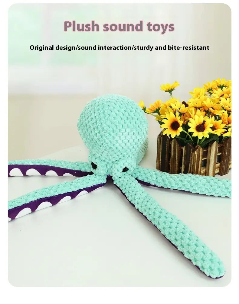 A mint green crocheted squeaky octopus plush pet toy with purple and white polka-dotted textured fabric tentacles.