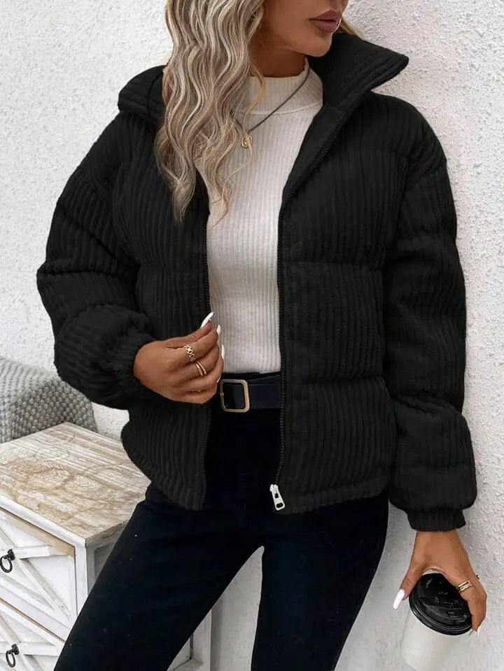 Black corduroy puffer jacket with a hood and front zipper designed as a plus size women winter coat.