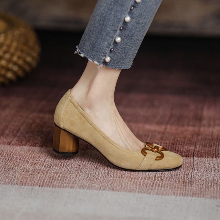 Beige suede square toe leather pumps with gold-tone buckle detail and wooden block heel.