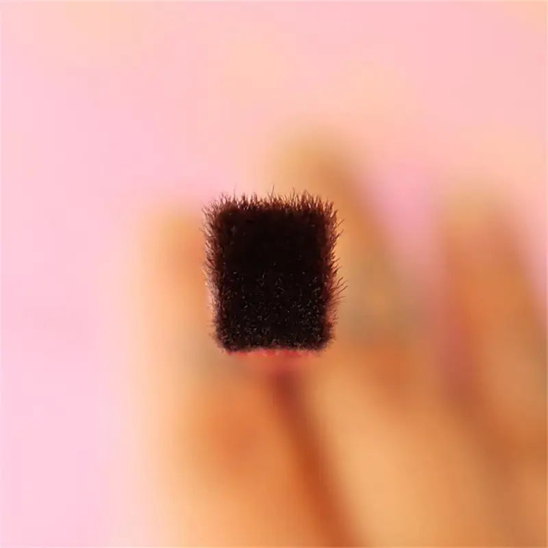 angled eyebrow and concealer makeup brush with a dense black square-shaped brush head and soft bristles for precise makeup application.