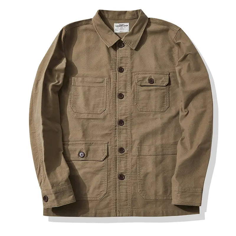 Mens french workwear jacket made of tan cotton canvas featuring multiple utility pocket flaps and brown buttons.