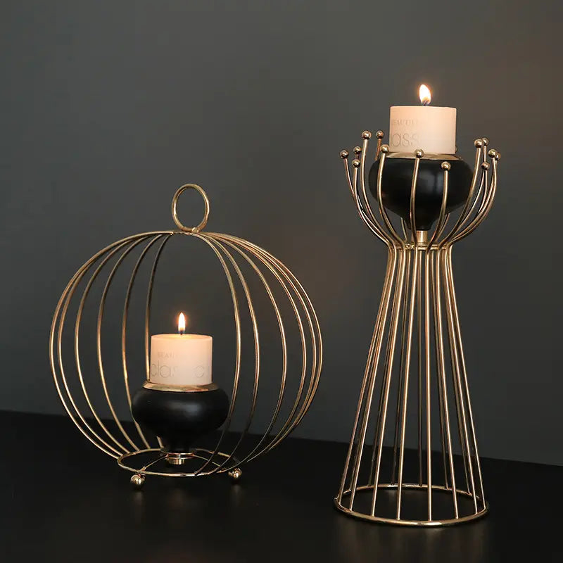 Gold geometric wire cage candle holder with black ceramic base featuring gold-toned metal construction in spherical cage and elegant vase shapes.
