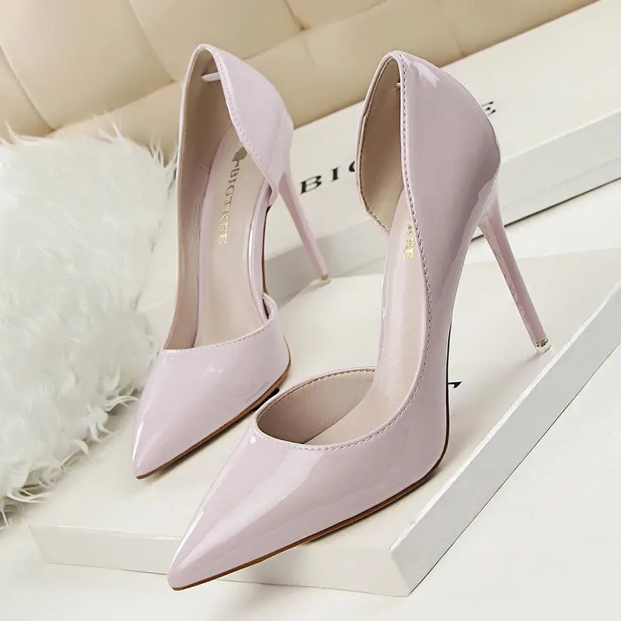 A pair of glossy lavender patent leather pointed toe stiletto high heels.