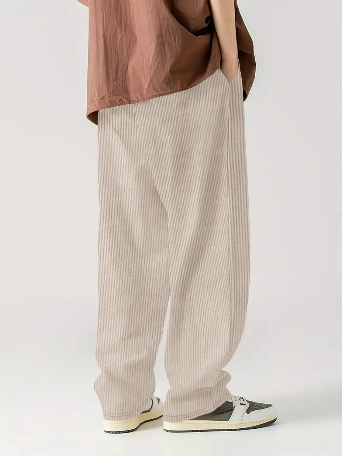 Pantalones casuales rectos de pana color beige con cordón, rayas verticales sutiles hechas con tejido texturizado.