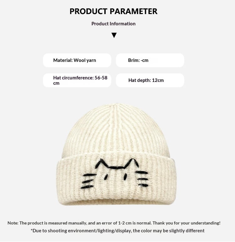 Cream-colored knitted beanie hat featuring a black embroidered cat face design.