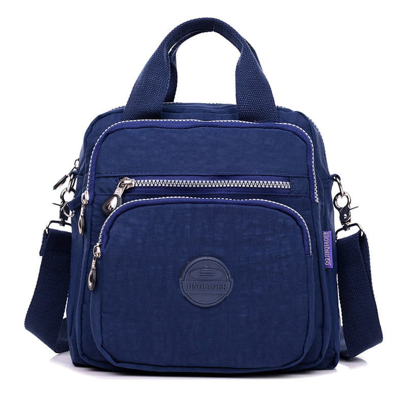 Navy blue nylon crossbody bag with top handle and multiple zippered compartments designed as a nylon messenger bag multi zipper canvas backpack.