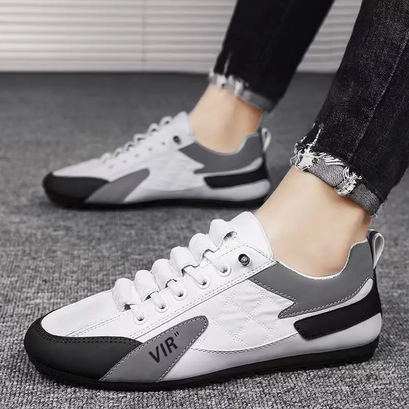 Men’s low top quilted athletic fashion sneakers in white and gray with black accents featuring a quilted design on the side panel.