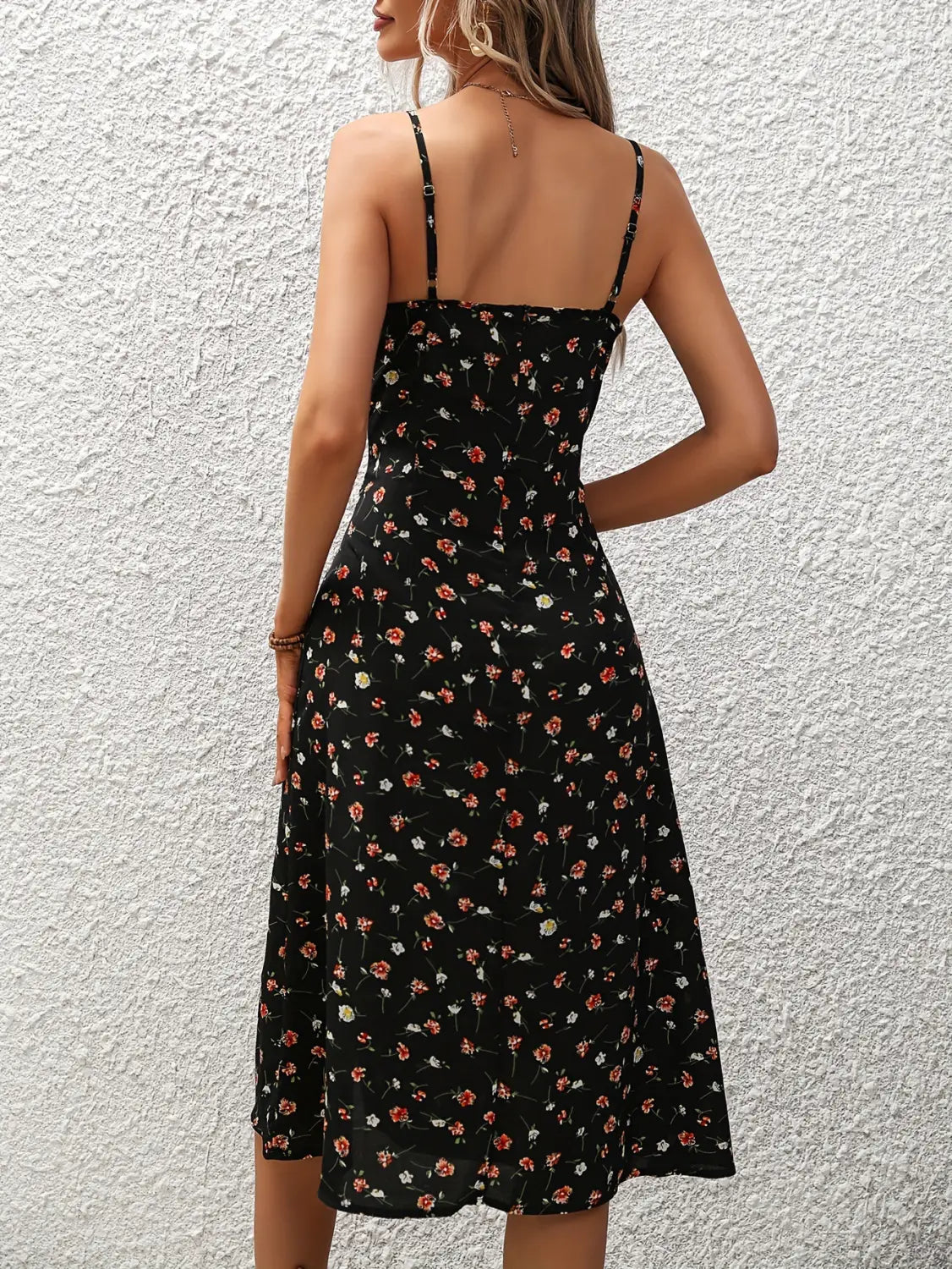 Black floral midi dress with thin spaghetti straps and a fitted bodice perfect for elegant occasions.