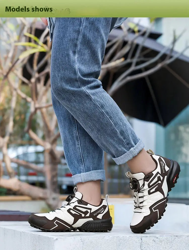White and brown lightweight off-road breathable hiking shoes with black accents featuring a modern design and visible outdoor branding on the side.