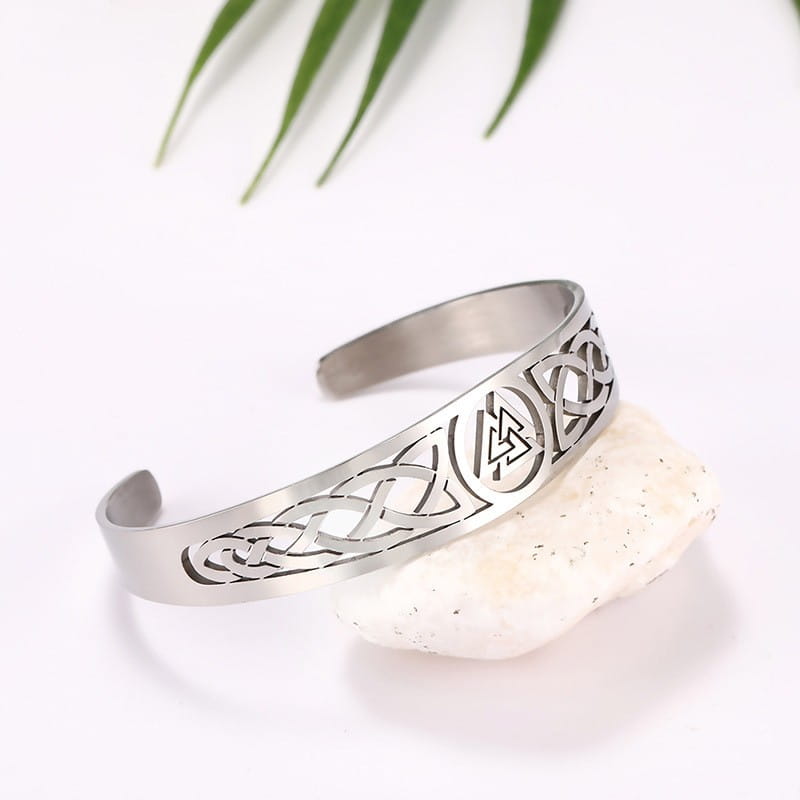 Silver-toned stainless steel cuff bracelet featuring intricate celtic knotwork and a central norse valknut rune design.