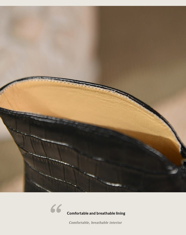 Black croc embossed leather stiletto ankle boot with tan breathable lining visible from the back side.