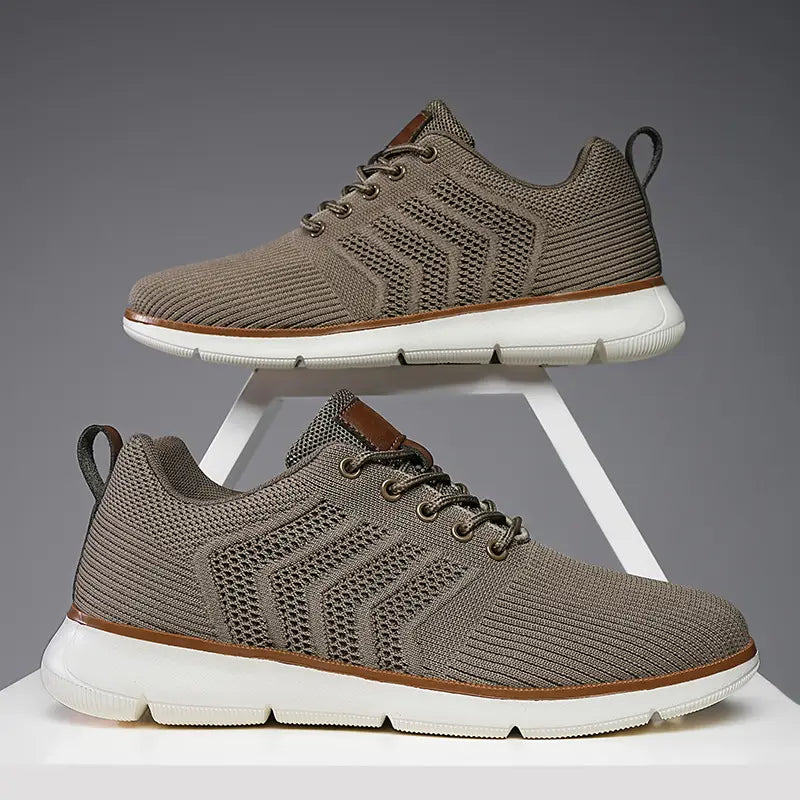 beige knit mesh sneakers for men with brown leather accents and a white rubber sole designed for casual flying woven shoes.