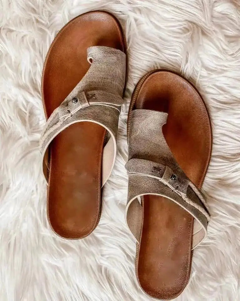 Beige suede women leather thong sandals with brown leather soles and decorative metal accents suitable for casual flat platform slides.