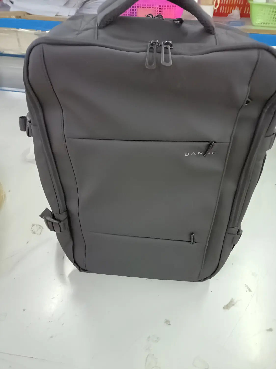 Gray fabric Bange 16 inch waterproof laptop travel backpack with a subtle bande logo on the front pocket.