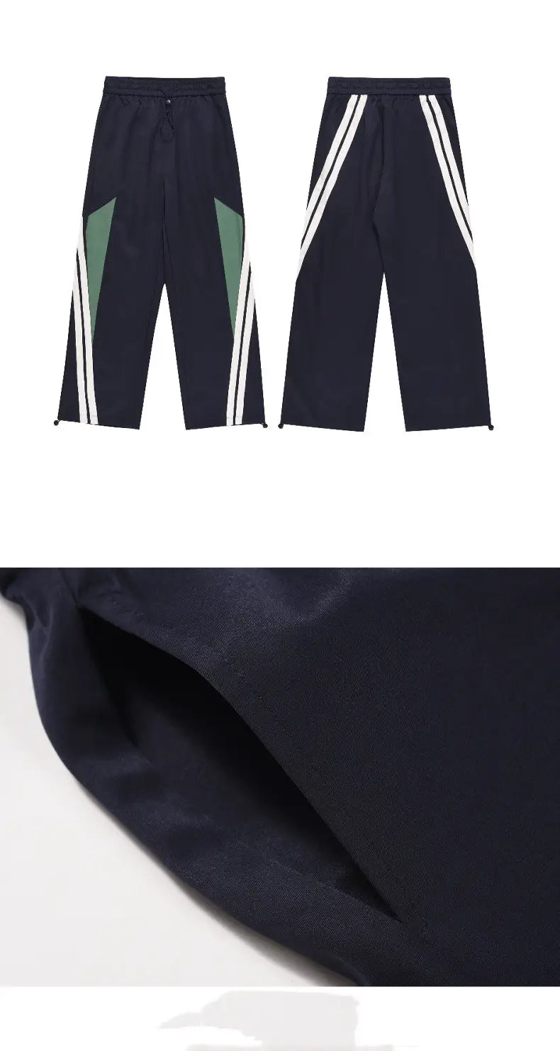 Men’s retro striped athletic track pants in dark navy featuring bold white and green geometric side panels.