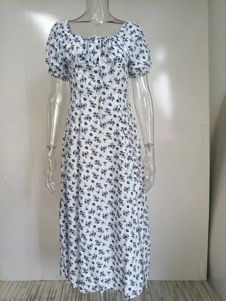 white floral print midi dress with short puffed sleeves and square neckline featuring a midi slit for a stylish and elegant look
