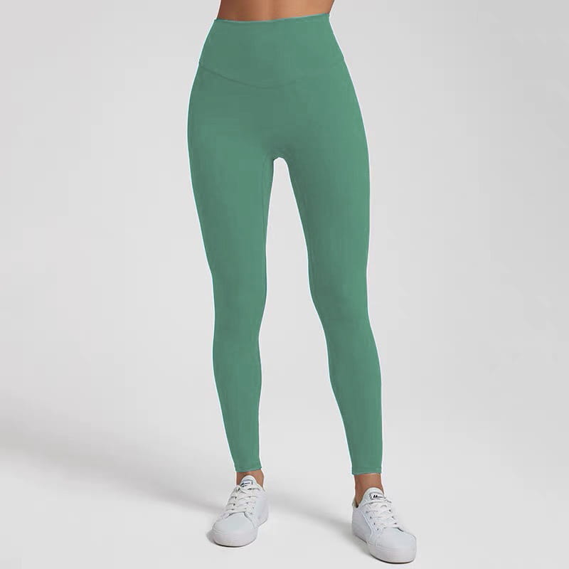 A pair of high waisted stretch fitted leggings in solid sage green made from stretchy fabric.