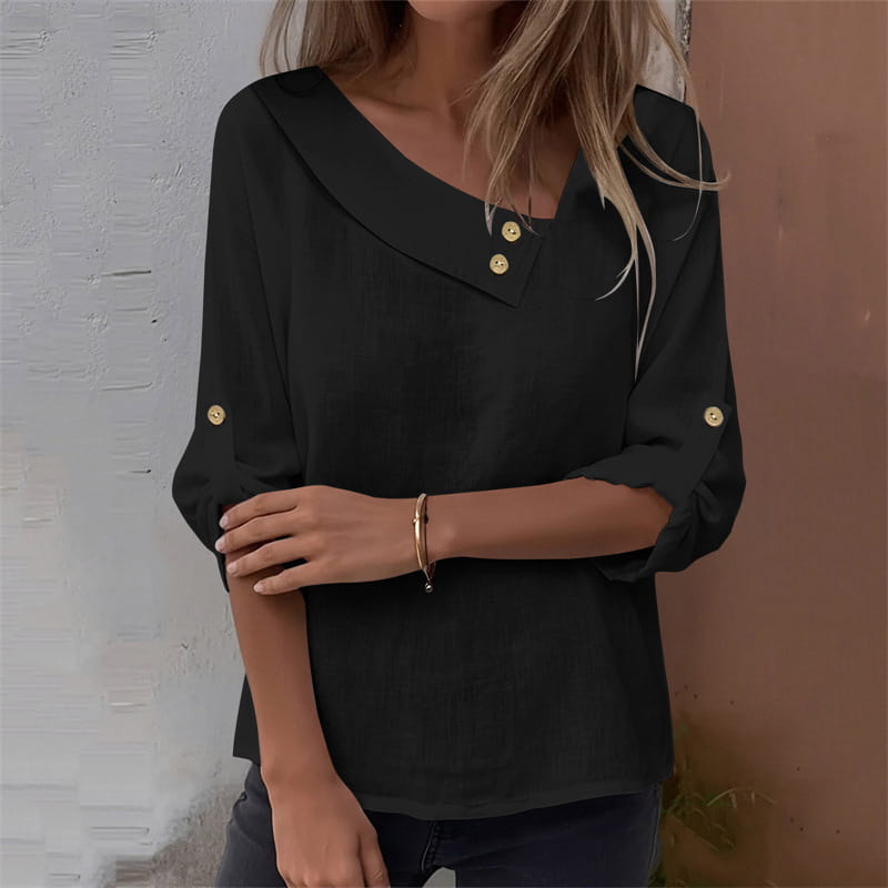 Black asymmetric button blouse with soft flowing fabric gold tone buttons at the neckline and three quarter sleeves.