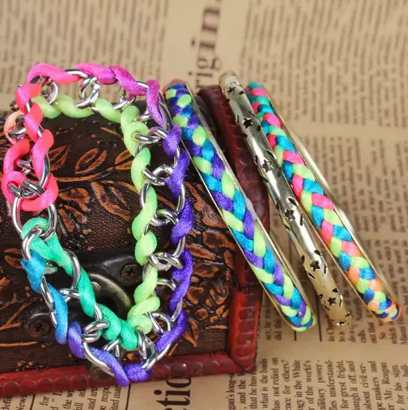 A vibrant multicolored neon braided gold bangle bracelet set with silver chain link design and star accents.