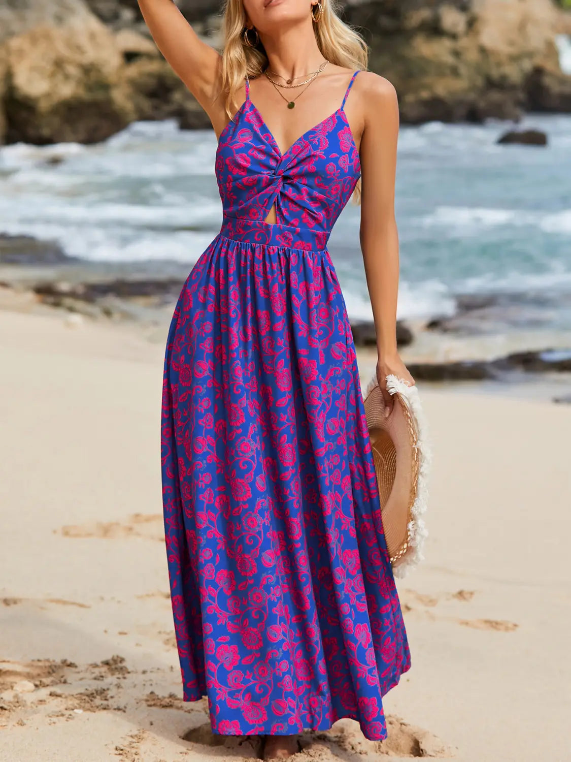 A vibrant purple and pink floral print maxi dress with a fitted bodice and front knot detail featuring spaghetti straps and a v neck.