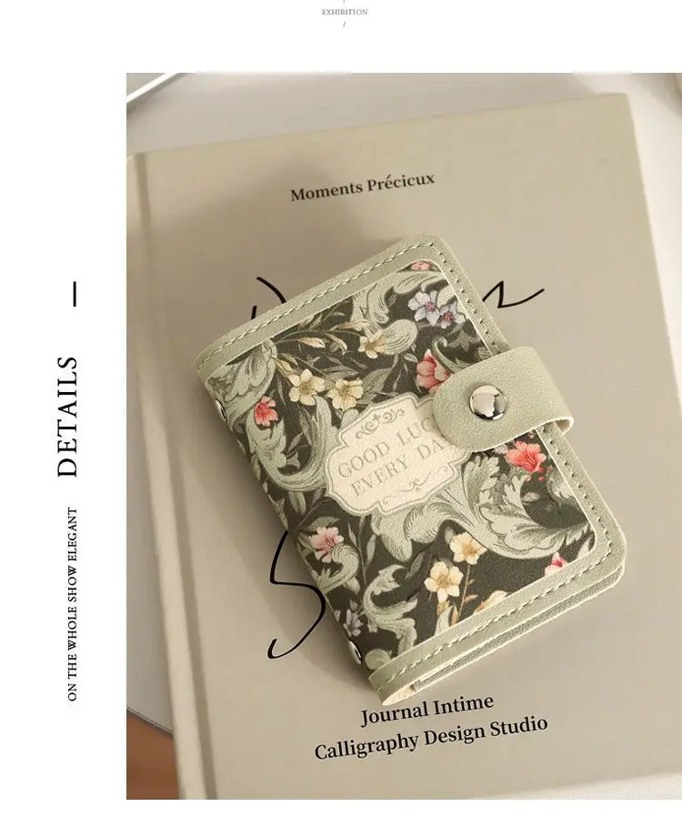 Vintage floral leather card holder wallet featuring a delicate floral pattern in soft sage green leather with silver-toned snap closure and elegant stitched edges.