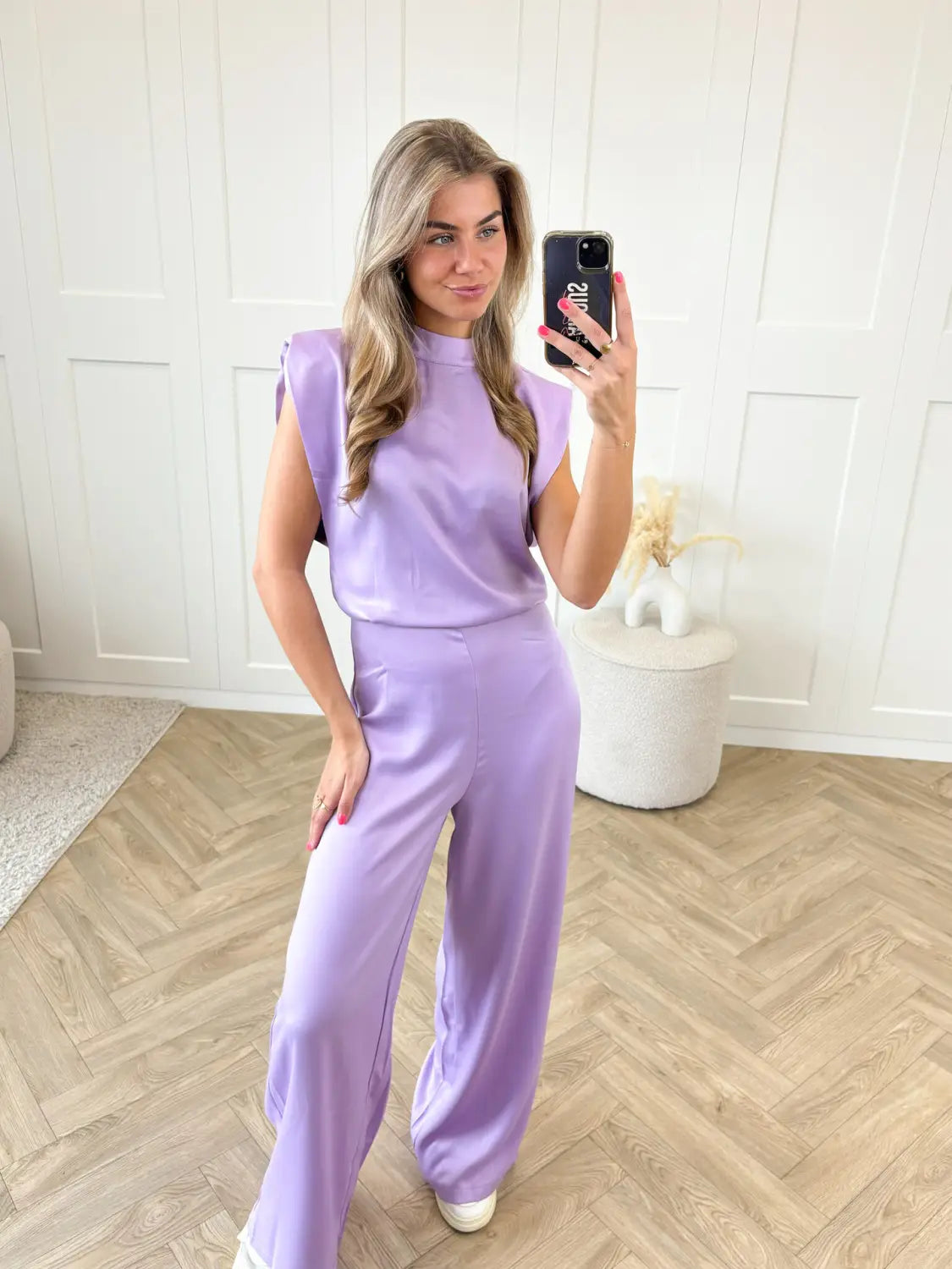 Lavender satin sleeveless jumpsuit with high neckline wide-leg pants and backless design ideal for evening wear.