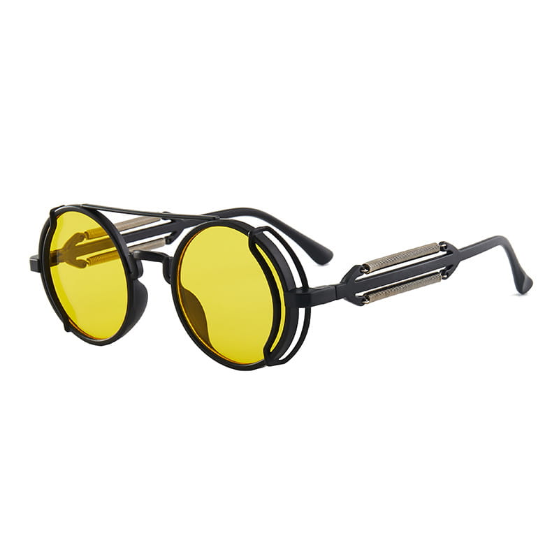 Gafas de sol steampunk redondas con monturas negras, lentes amarillas vibrantes, detalles metálicos en las patillas y doble resorte.