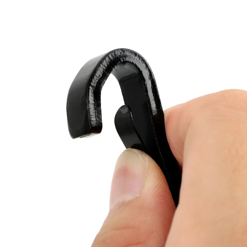 Black plastic glossy hook with curved shape held between fingers for universal Isofix car seat belt extender.