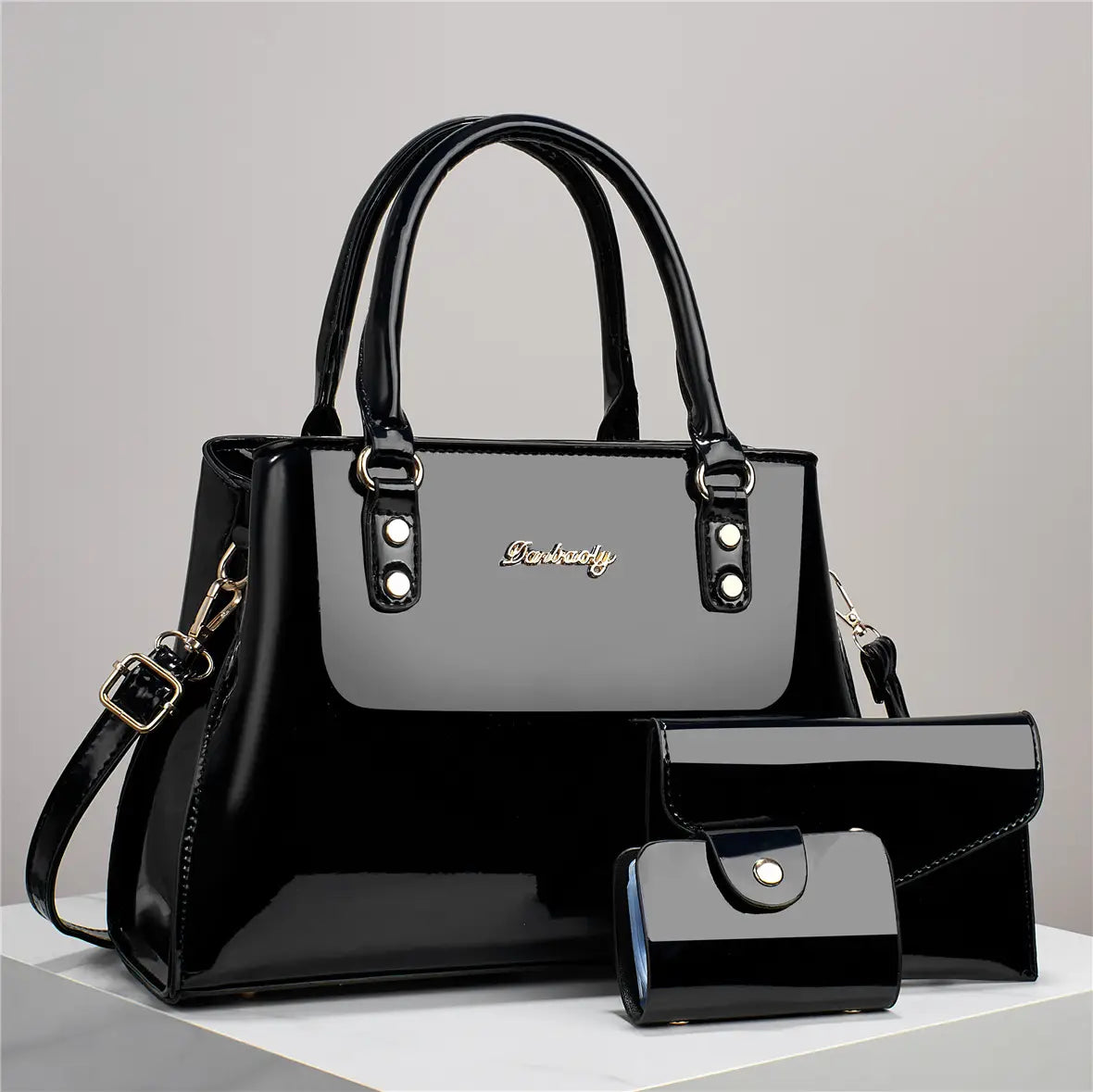 Glossy patent leather black handbag with silver hardware and matching wallet set for stylish organization and daily use.