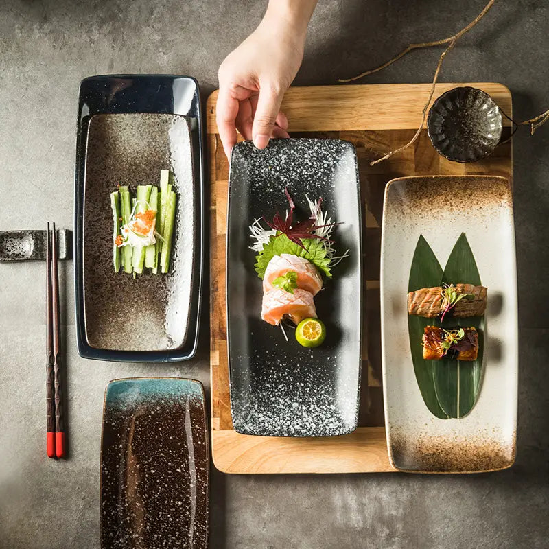Black rectangular ceramic sushi plate with speckled textured surface and subtle glaze finish for Japanese serving trays.