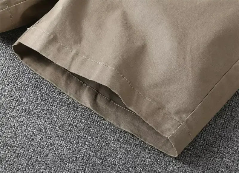 Men casual slim fit cargo shorts in khaki cotton fabric with neat stitching along the hem.