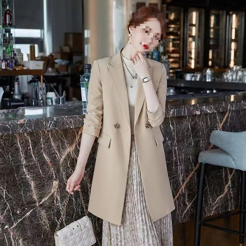 Beige double breasted casual blazer with rolled sleeves and gold toned buttons.