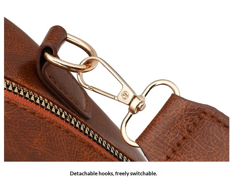 brown leather strap with gold-tone detachable hook and zipper detail on a faux leather women’s large capacity commuter backpack