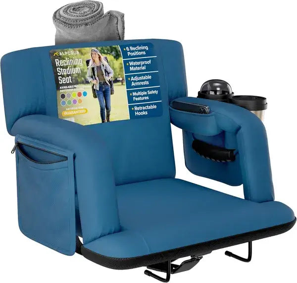 Alpcour premium reclining stadium seat in blue with armrests featuring integrated cup holders and a rolled-up gray blanket on the backrest.