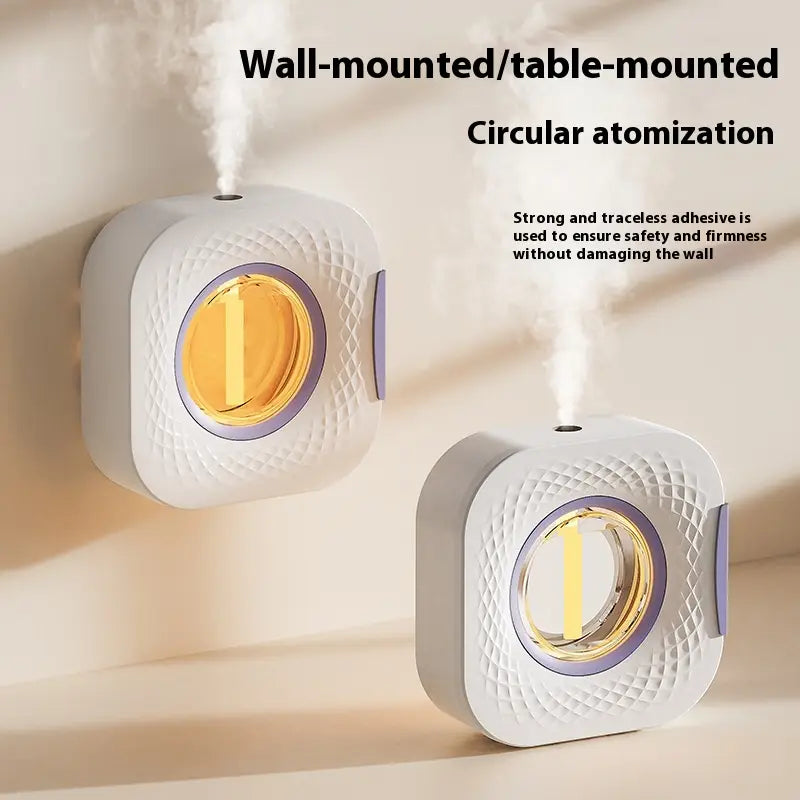 A white and purple circular wall-mounted aroma diffuser smart rechargeable dispenser with a textured surface and glowing amber interior.