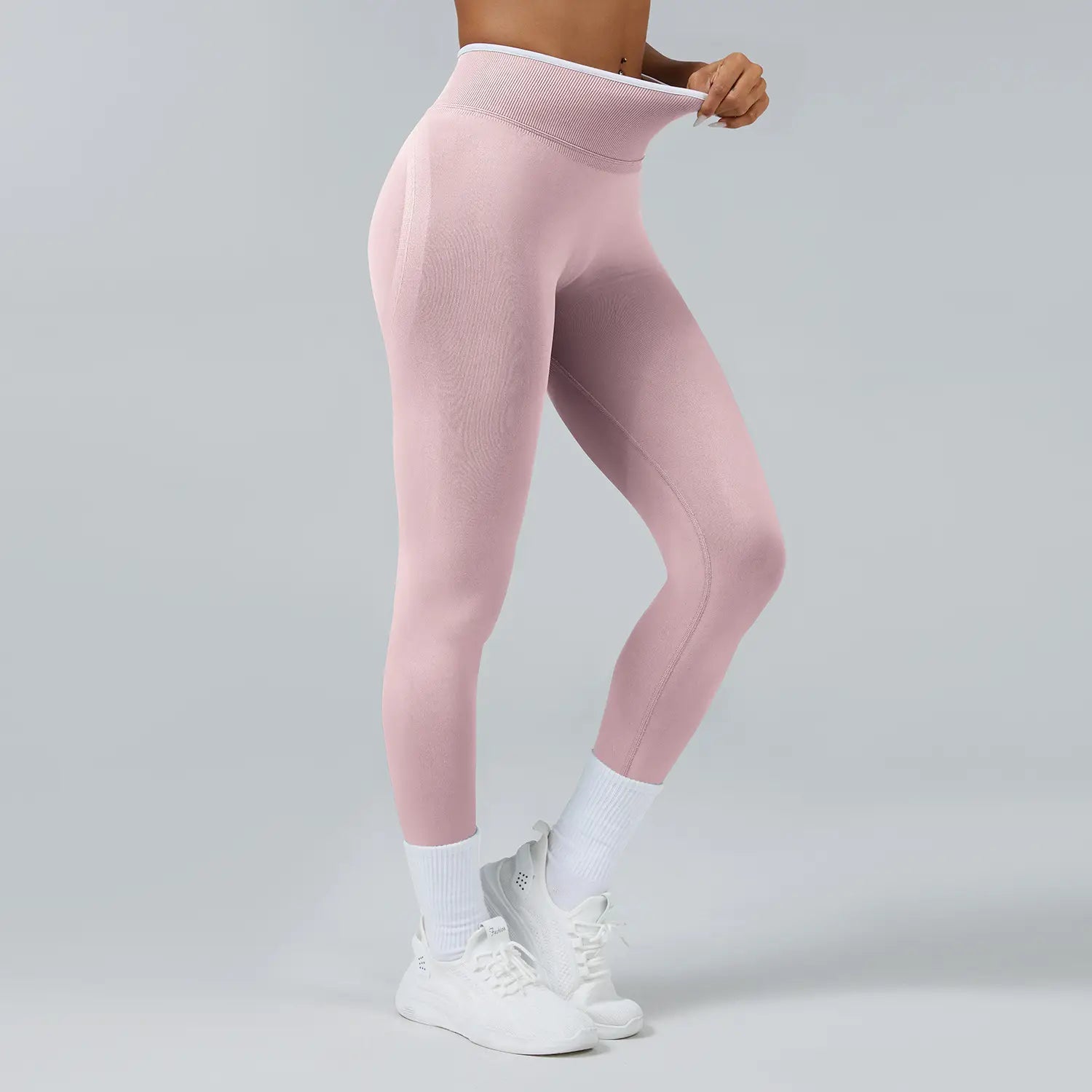 Rosa nahtlose Sport-Yoga-Leggings mit hoher Taille aus einem strukturierten, dehnbaren Stoff und einem weißen elastischen Bund