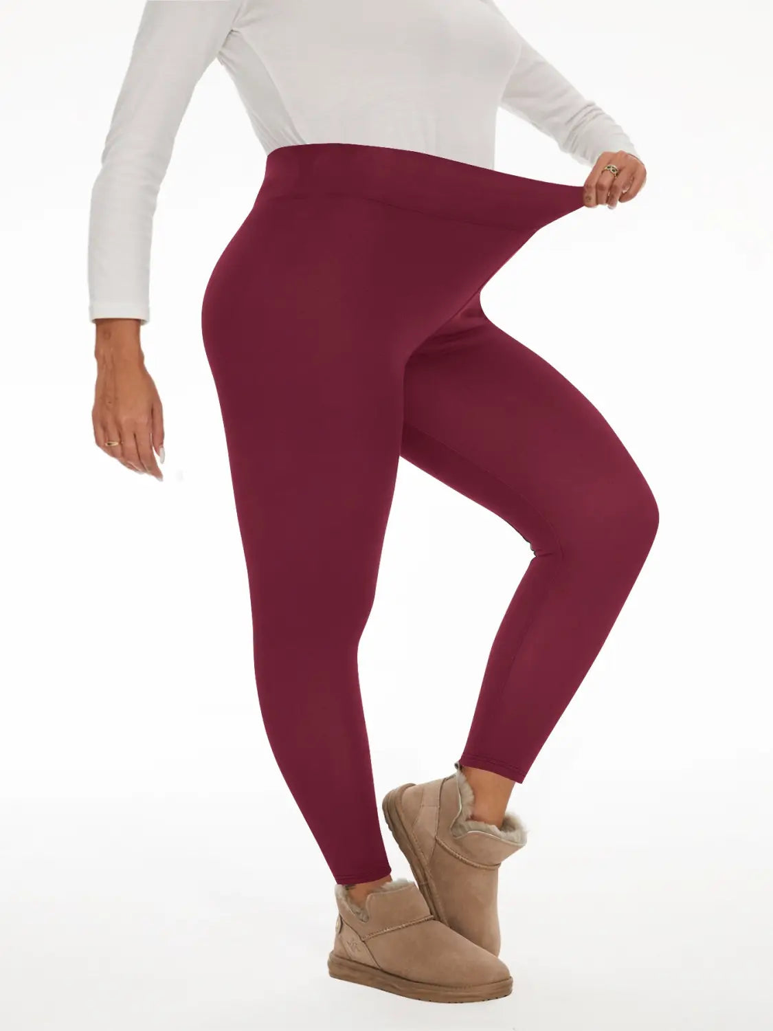 Maroon fleece lined high waisted winter leggings made of smooth stretchy fabric.