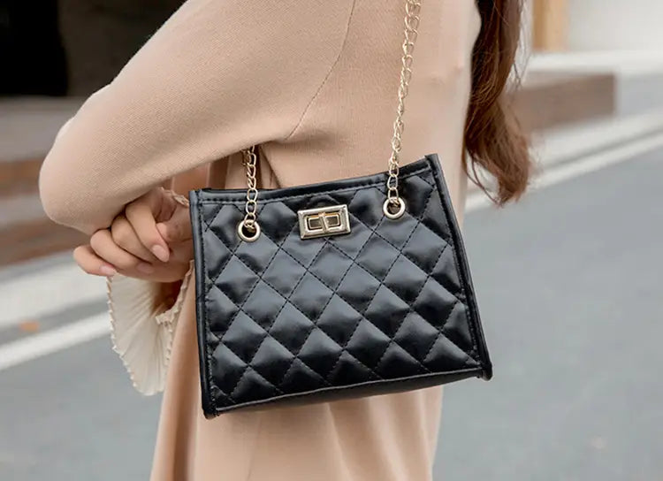 Black quilted leather mini chain shoulder bag with rhombus pattern small square shape gold tone chain strap and rectangular clasp