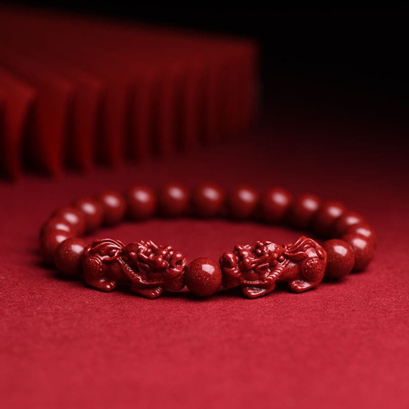 Hand carved purple gold cinnabar double pixiu bracelet featuring a red dragon-themed design with polished wooden beads and intricately carved figurines.