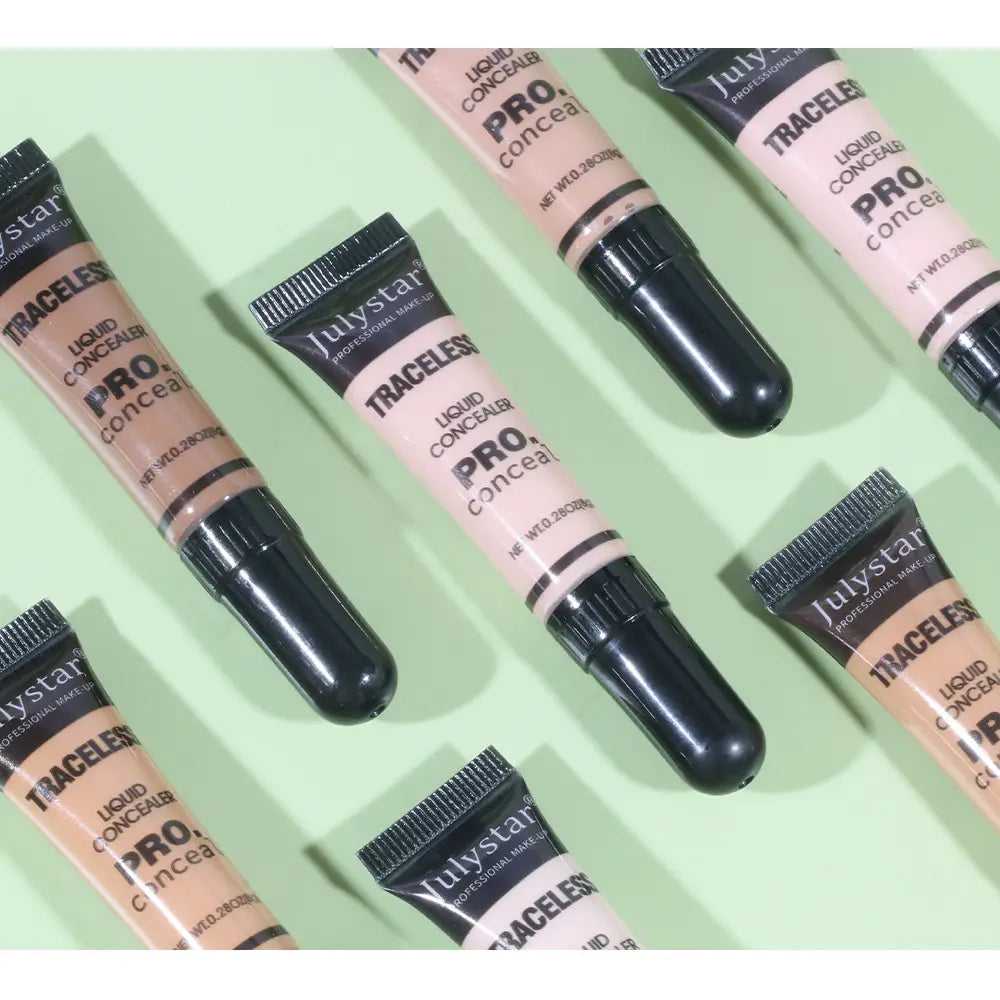 Julystar traceless pro liquid makeup tattoo concealer tubes in beige and brown shades with black caps for natural coverage.