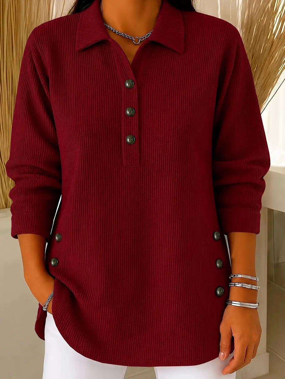 A maroon ribbed knit long-sleeve polo shirt with dark green buttons down the front and side seams designed as a casual ribbed button up sweatshirt long sleeve top.