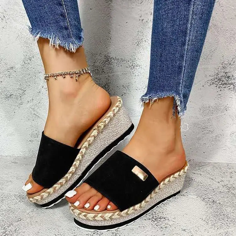 Black suede platform wedge espadrille sandals with woven heel and metallic rectangular buckle detail.