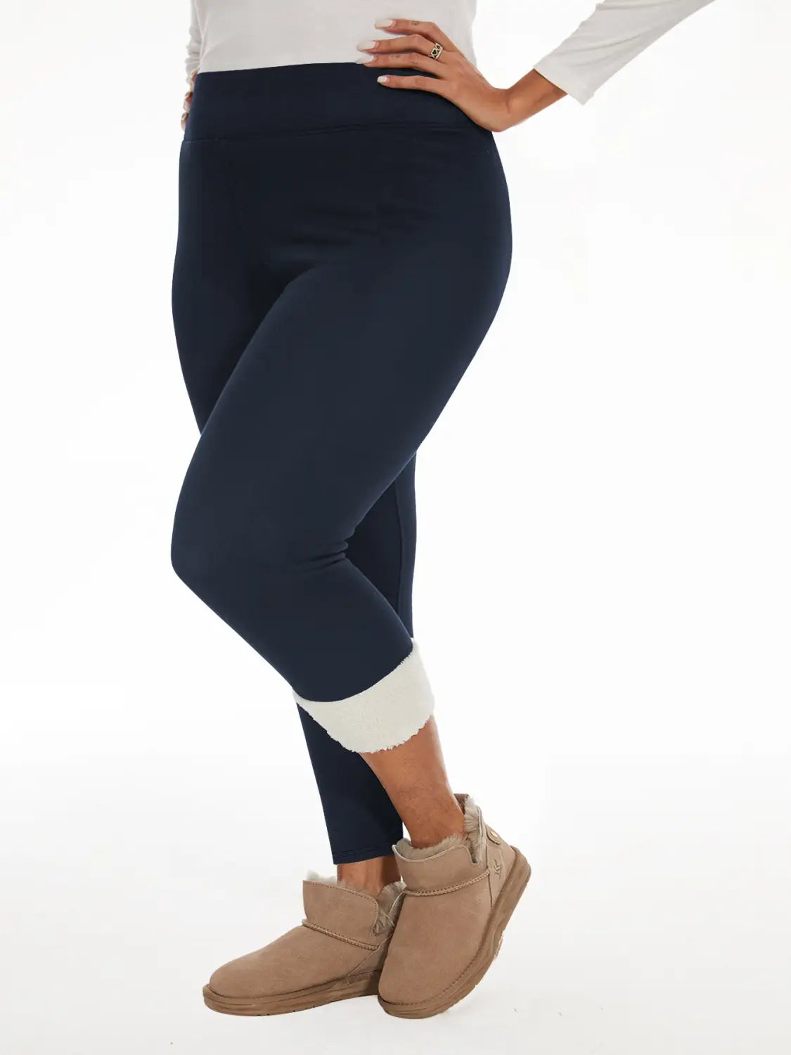 Navy blue fleece lined high waisted winter leggings with white scalloped cuff at the ankle.