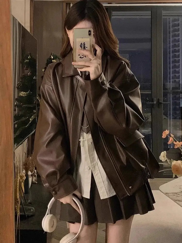 Brown faux leather bomber jacket with an oversized short coat design featuring a relaxed fit and subtle stitching details.